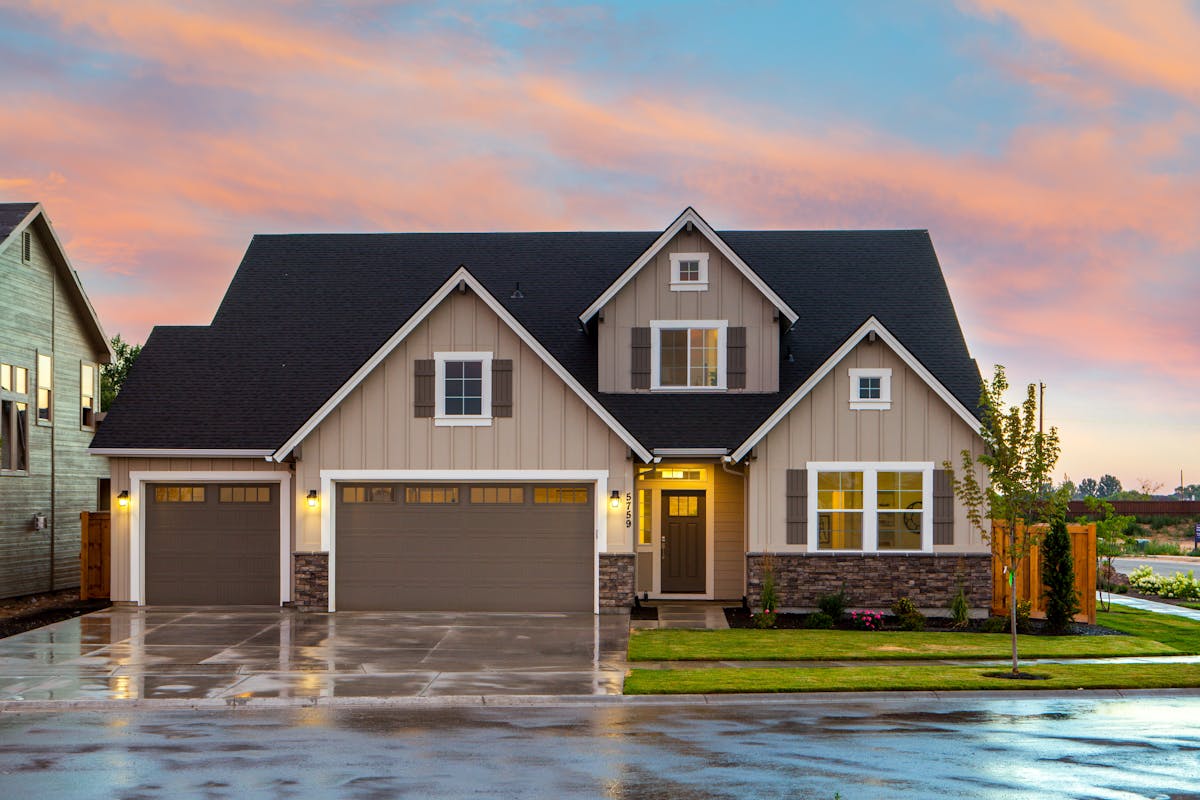 A duplex property with well-maintained landscaping, representing house hacking investment strategy